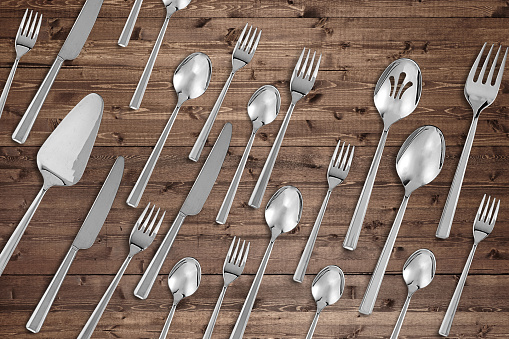 Kitchen flatware cutlery set on a rustic wood background