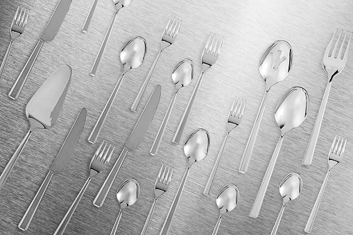 Kitchen flatware cutlery set on a stainless steel background