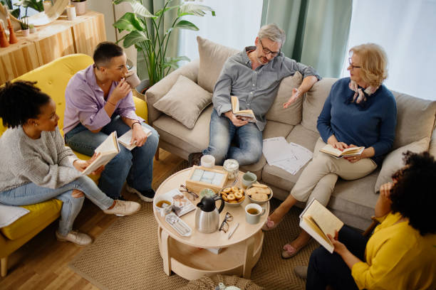istock Diverse group of friends discussing a book 1392840382