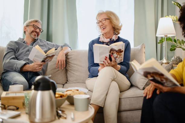 istock Diverse group of friends discussing a book 1392840383