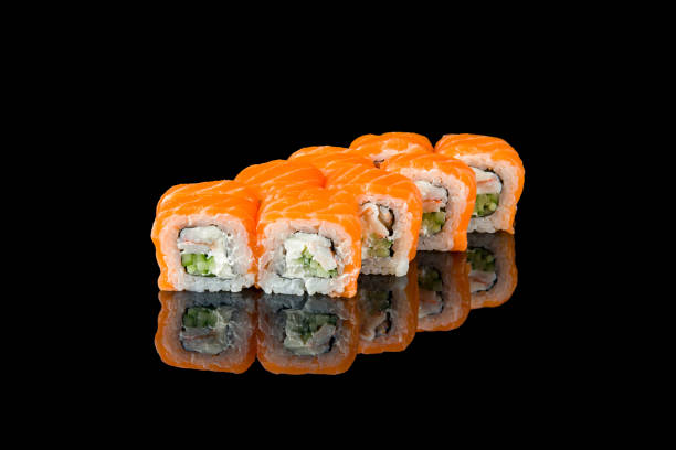 istock Philadelphia roll with salmon and shrimp on black with reflection 1392842050