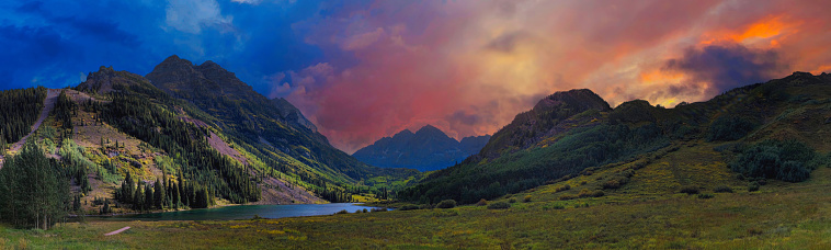 Panoramic picture of Maroon Bells are two peaks in the Elk Mountains, into calm Maroon Lake near Aspen, Colorado, United State.