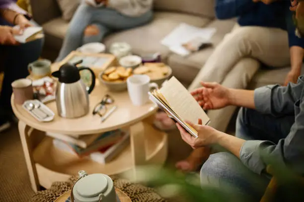 Group of diverse people socialising during book club meeting