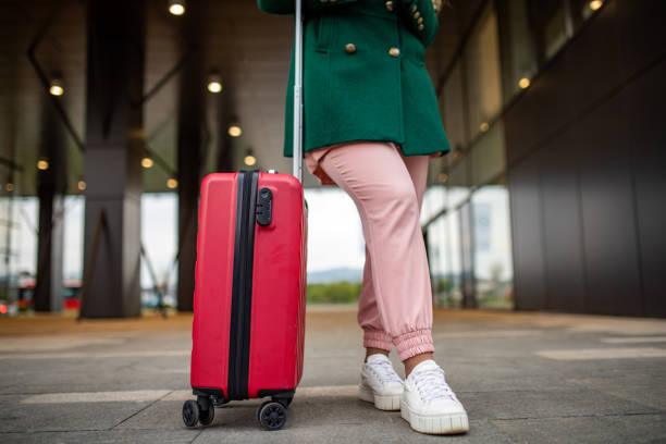 istock Young woman going on vacation with luggage 1392844092