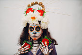 Woman with mexican skull halloween makeup on her face. Day of the dead and halloween