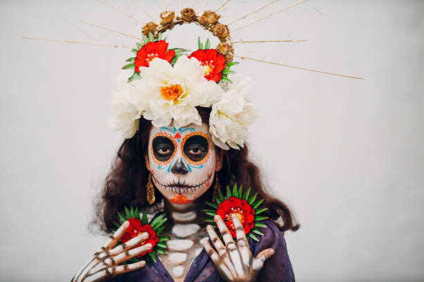 Woman with mexican skull halloween makeup on her face. Day of the dead and halloween Woman with mexican skull halloween makeup on white background. Day of the dead aka Dia de los Muertos and halloween concept. halloween face paint stock pictures, royalty-free photos & images