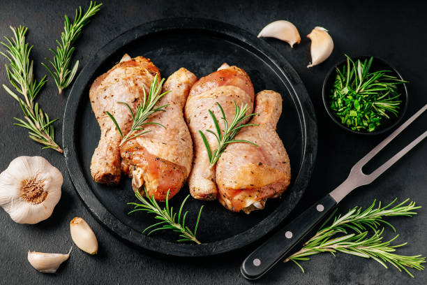 istock Banner of BBQ drumstick.Raw marinated chicken meat.Chicken drumstick marinated with fresh spices.Close-up of chicken legs with spices on a plate for cooking on a dark background with spices. 1392847963