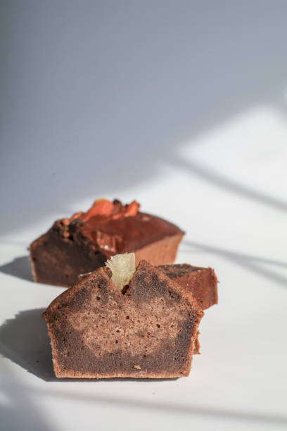 istock Banana bread with nut under sunlight on white background. Morning breakfast background. Close up view. 1392849395