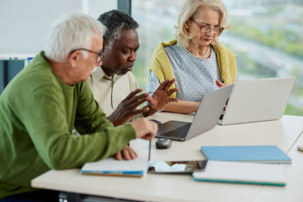 istock A multicultural group of senior students is talking and doing a project on laptops in the classroom. 1392850177