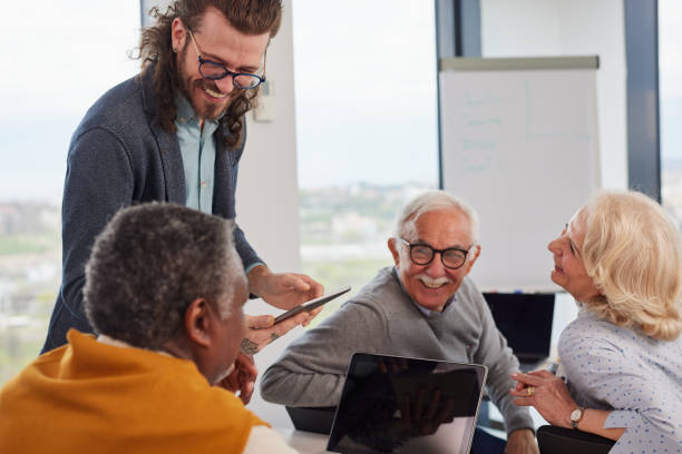 istock A multicultural group of elderly students discusses an assignment with their young educator in the classroom. 1392850214