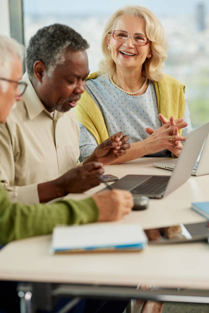 istock A cheerful multicultural group of senior students is doing an assignment on laptops in the classroom. 1392850222