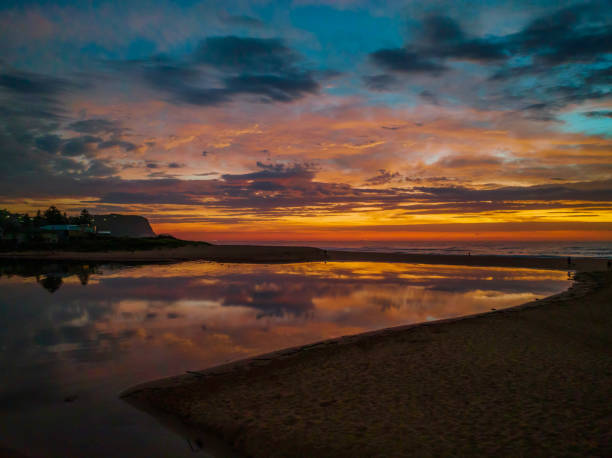 istock Dawn reflections and clouds at the seaside with lagoon 1392851196