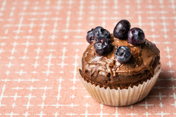 istock fresh baked muffin with chocolate cream and blueberries on the table copy space 1392853707