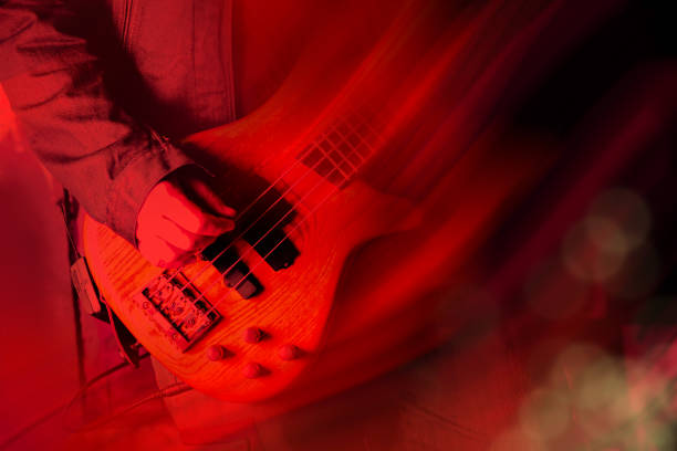 istock Playing electric guitar in red light 1392866619