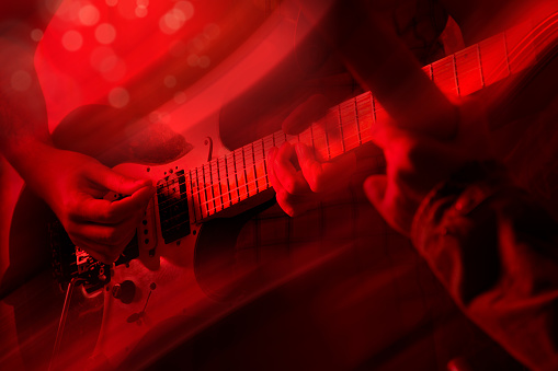 Close up man playing electric guitar