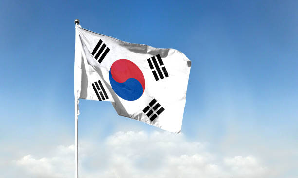 istock Korean flag  with blue sky. waving blue sky 1392866764