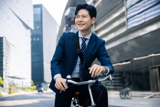 istock Businessman riding bicycle portrait 1392867375