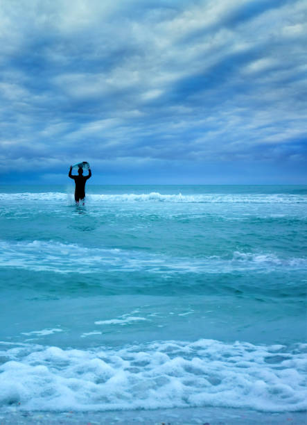 Young male surfer and dramatic seascape