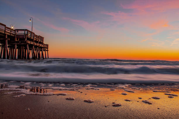 Beach sunrise at the Sandbridge pier stock photo