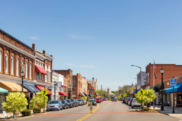 Wide-angle view of Main St., Mooresville, NC Mooresville, NC, USA-17 April 2022: Iconic, colorful wide-angle Main Street view on a sunny, blue sky, spring day. Looking toward Bay State Milling Co. small town america stock pictures, royalty-free photos & images