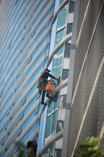Washing windows pro team on high rise building