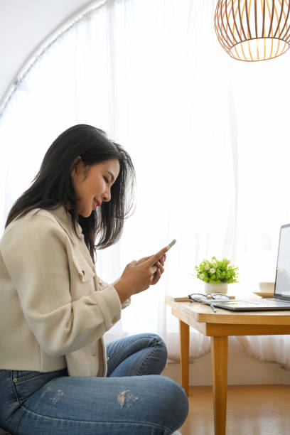 istock Woman relaxing in the cafe, using her smartphone. 1392876053