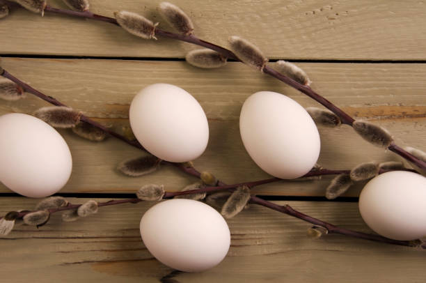 istock Eggs and willow on a wooden background 1392879580