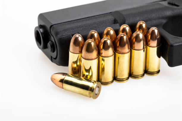 9 mm. gun bullets , full metal jacket ammunition and automatic handgun on white background - full metal jacket imagens e fotografias de stock