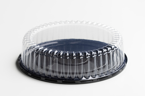 Plastic cake container with clear dome lid isolated on a white background.