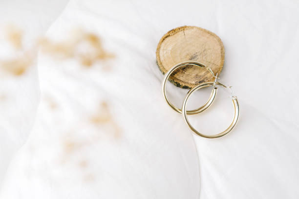 istock Golden modern bijouterie earrings on white background. 1392883609