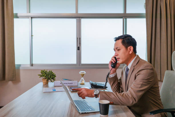 istock Asian businessman working in the office with computer laptop. 1392884599