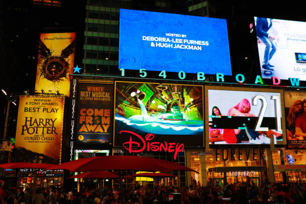 Times Square is a busy tourist intersection of neon art NEW YORK, USA - August 30, 2018: Times Square is a busy tourist intersection of neon art and commerce and is an iconic street of New York City and America broadway manhattan stock pictures, royalty-free photos & images