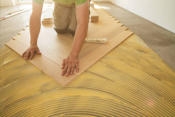 istock Craftsman laying herringbone parquet flooring professionally 1392888210