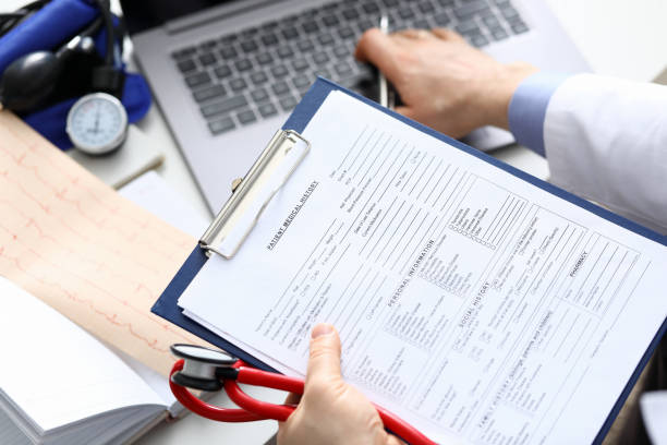 istock Filling out patient medical history, personal data 1392889303