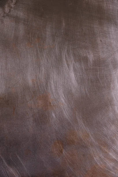 istock Polished copper plate with scratches and oxidative spots. 1392889509