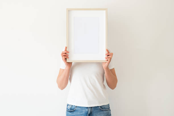 istock A wooden frame with empty space in women's hands 1392889602