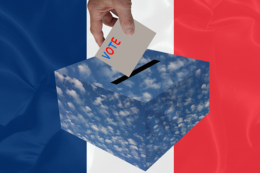 Vote in France  Hand dropping a ballot paper into an election box   French Flag Background