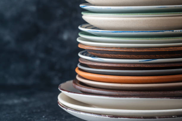 istock Many empty plate on black background, close up 1392890798