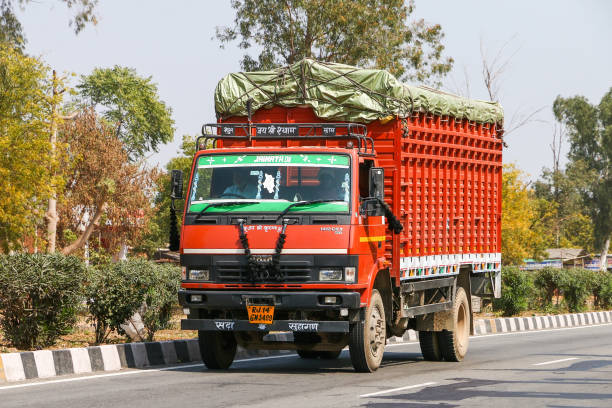 Uttar Pradesh, India - February 27, 2022: Red cargo van Tata LPT 1412 CRX at an intercity road.