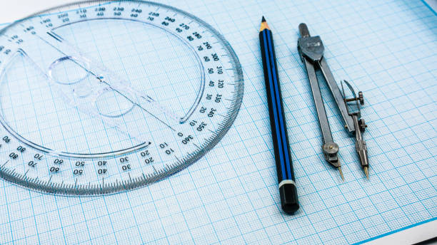 istock On blue graph paper are compasses, protractor, ruler, and a pencil 1392893011