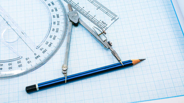 istock On blue graph paper are compasses, protractor, ruler, and a pencil 1392893139