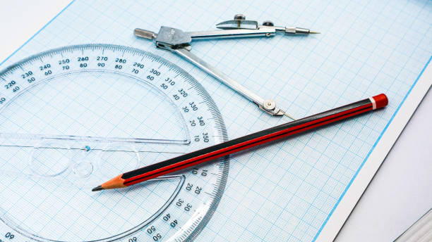 istock On blue graph paper are compasses, protractor, ruler, and a pencil 1392893332