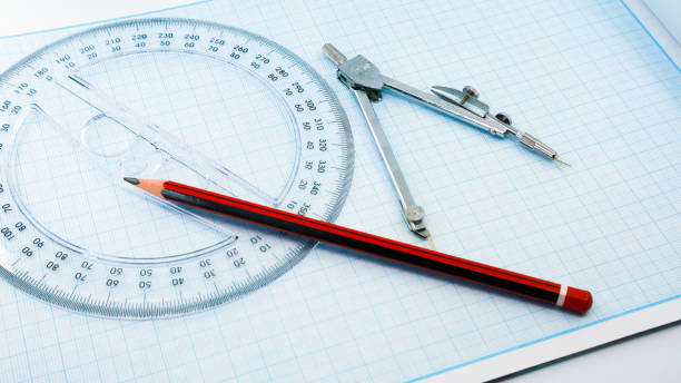 istock On blue graph paper are compasses, protractor, ruler, and a pencil 1392893367