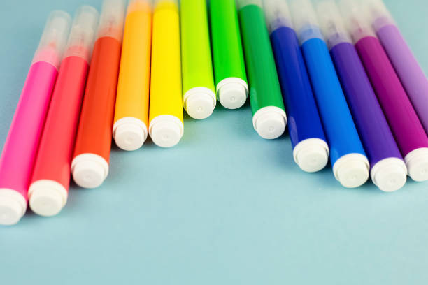 istock Bright rainbow markers on a blue background with copy space. 1392896359