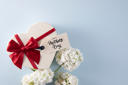 Happy Mother's Day gift tag with heart shaped gift box on blue background