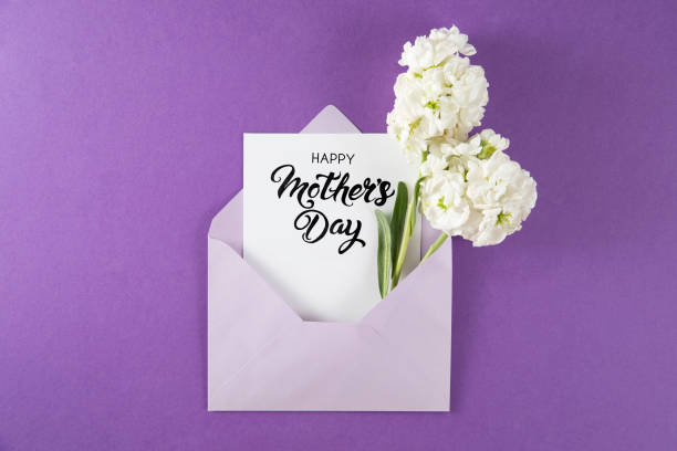 istock White Flowers with White Greeting Card in Purple Envelope 1392900683
