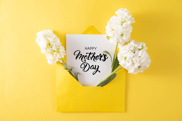 istock White Flowers with White Greeting Card in Yellow Envelope 1392900840