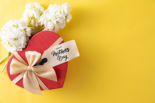 Happy Mother's Day gift tag with red heart shaped gift box on yellow background