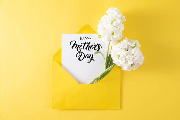 istock White Flowers with White Greeting Card in Yellow Envelope 1392901020
