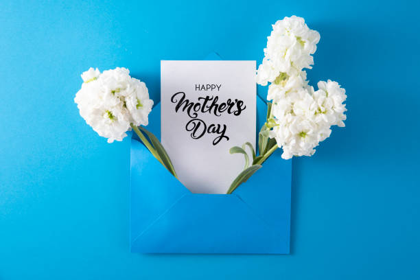 istock White Flowers with White Greeting Card in Blue Envelope 1392901875